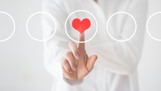 A Functional Medicine Doctor in Downers Grove IL pressing a button with a heart in it