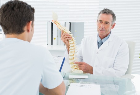 Chiropractor Hinsdale IL image Chiropractor Hinsdale IL showing a patient a model of a spine