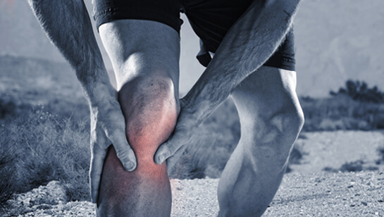 Runner holding knee in pain requiring Natural Remedies for Joint Pain in Clarendon Hills IL