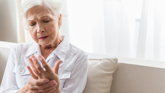 Elderly woman holding hand requiring Natural remedies for joint pain relief in Clarendon Hills IL